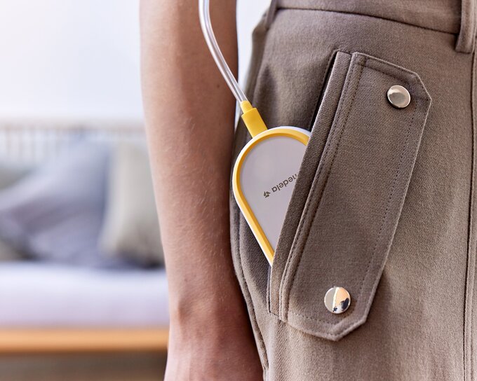 Freestyle™ Hands-free double electric wearable breast pump Medela Freestyle™ Hands-free double electric wearable breast pump tucked into mom's pocket