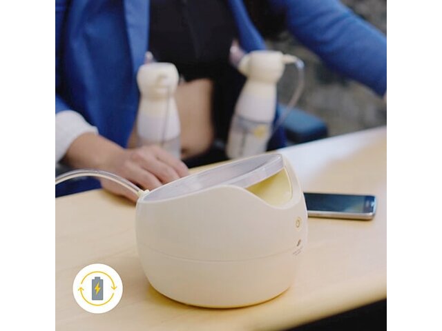 Mom working at desk while double pumping using her Medela Sonata® Smart double electric breast pump with rechargeable battery icon