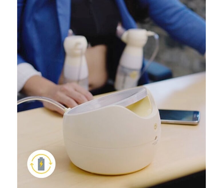 Mom working at desk while double pumping using her Medela Sonata® Smart double electric breast pump with rechargeable battery icon