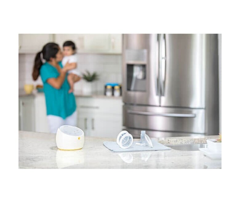Medela Sonata® Smart double electric breast pump and parts sitting on countertop after cleaning