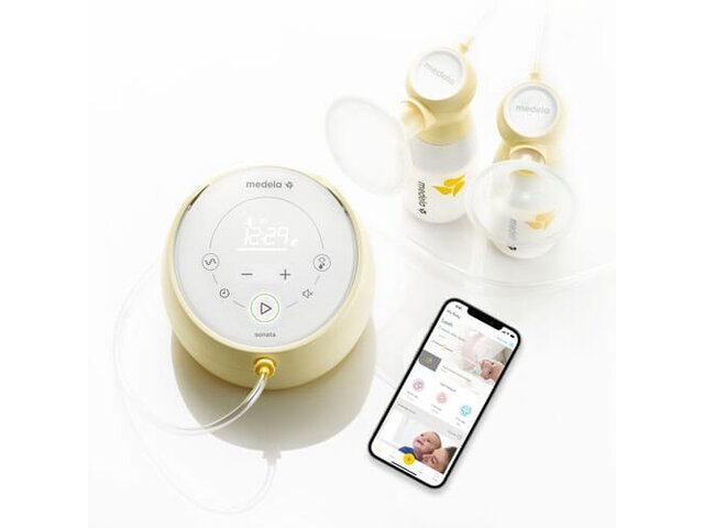 Medela Sonata® Smart double electric breast pump shown with breast shields, storage containers, tubing and a cell phone open to the Medela App