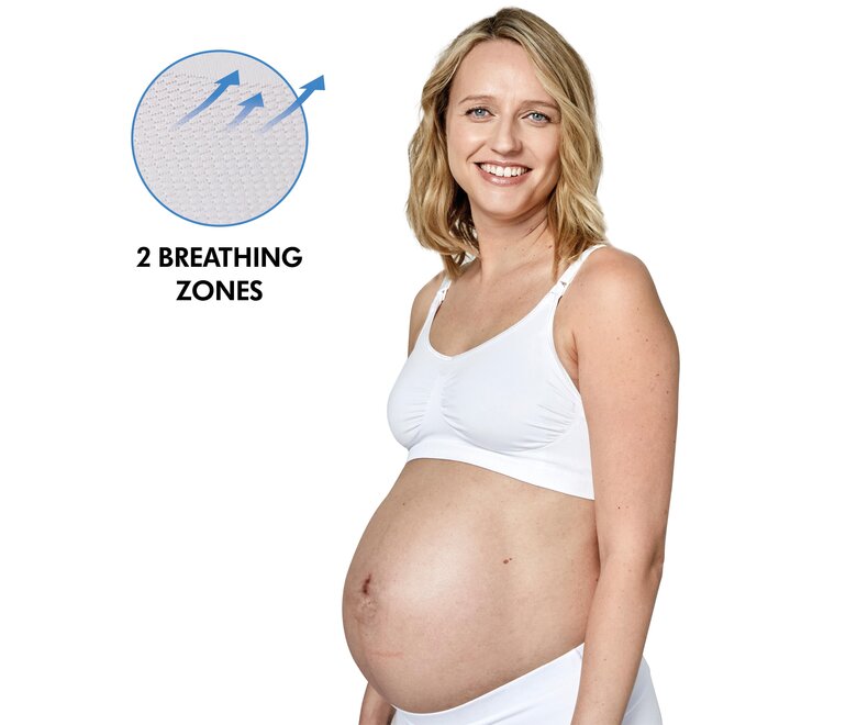 Mãe a usar um soutien Medela Keep Cool™ branco vista lateral com o texto “2 zonas de respiração”