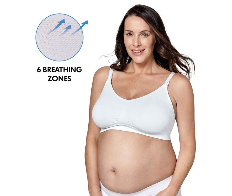 Mulher a usar um Medela Keep Cool™ Ultra Bra branco, vista frontal com o texto “6 zonas de respiração”