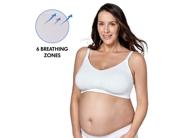 Woman wearing a white Medela Keep Cool™ Ultra Bra front view with text, "6 breathing zones"