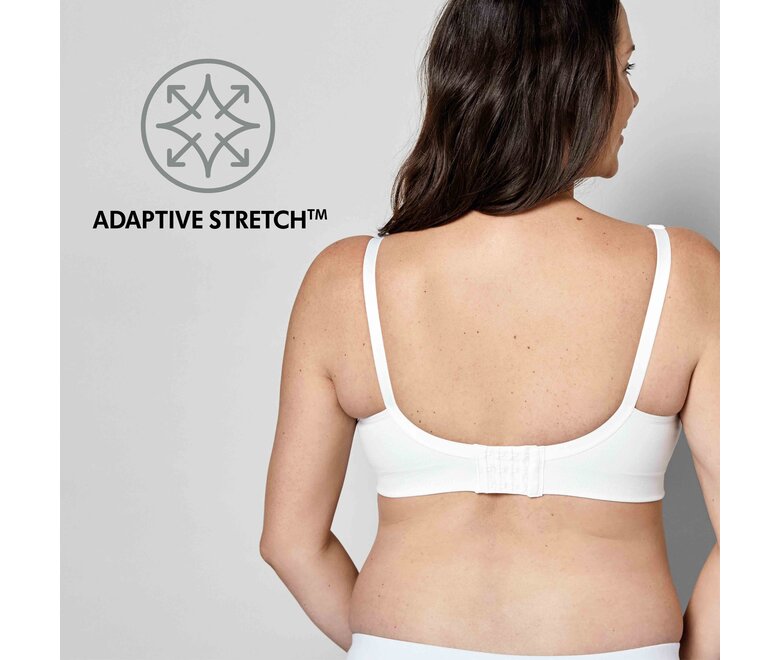 Mulher a usar um sutiã Medela Keep Cool™ Ultra Bra branco, vista posterior com o texto “Adaptive Stretch”