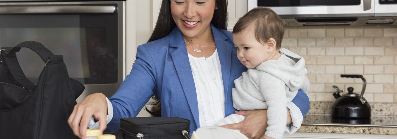 Working Mom packing up her Medela Sonata® breast pump and Cooler Bag with filled breast milk storage bottles