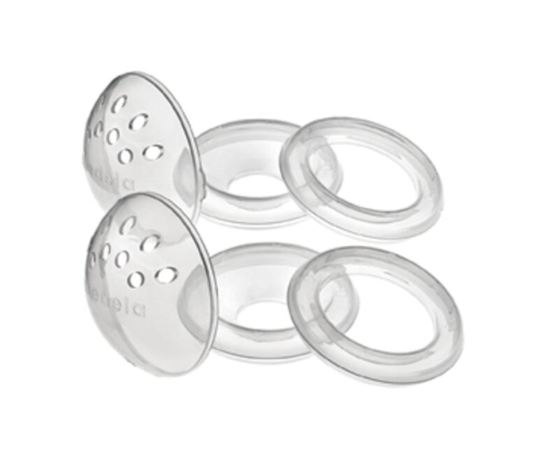 A pair of Medela TheraShells™ Breast Shells, disassembled into its 3 parts: dome, cone and ring.