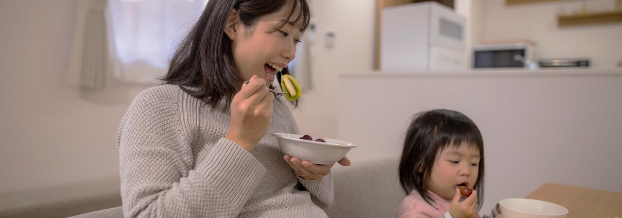 Pregnant woman enjoying a healthy meal, emphasizing the importance of nutrition during pregnancy.