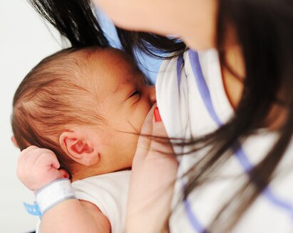 A new mom breastfeeds her newborn.