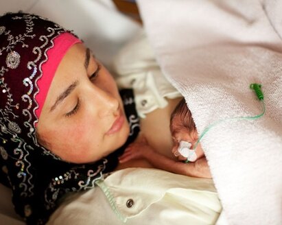 A premature baby has skin-to-skin contact with its mother.