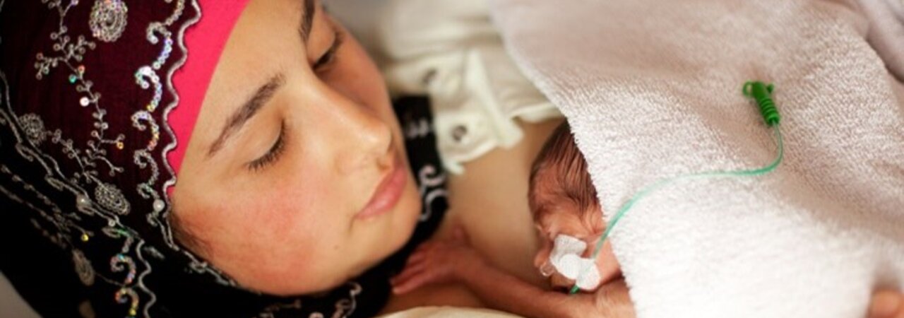 A premature baby has skin-to-skin contact with its mother.