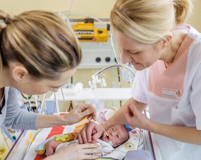 A premature baby receives oral therapy in the NICU.