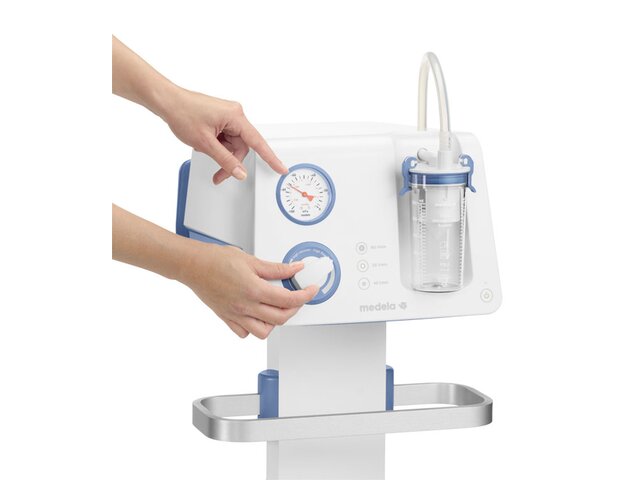 Hand adjusting vacuum setting on a Medela Dominant Flex Pump