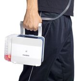 Man carrying a Medela Thopaz+ digital chest drainage and monitoring system* for use after thoracic surgery and interventions