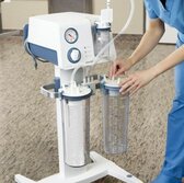 A healthcare professional sets up a Medela Dominant Flex surgical suction pump with a reusable canister in a hospital.