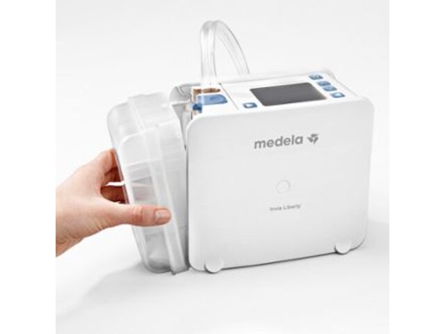 Photo shows a hand changing the canister on a Medela NPWT Invia pump.