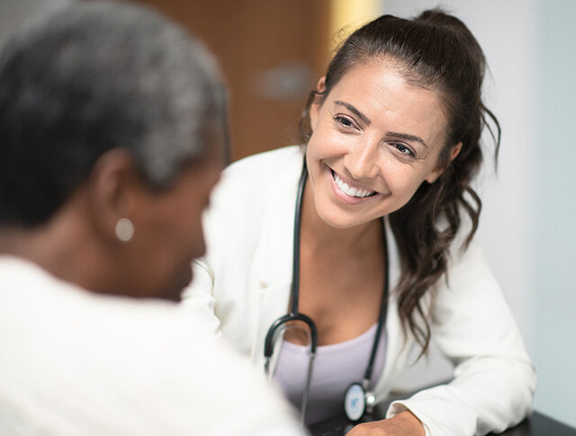 Medical professional speaking with a patient