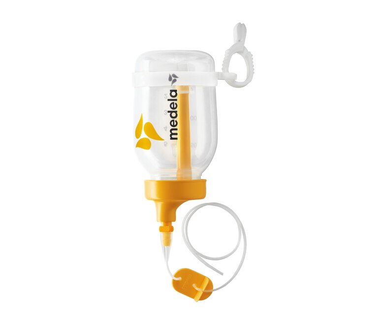 Een geassembleerd Supplemental Nursing System™ (SNS) met de bijbehorende onderdelen.