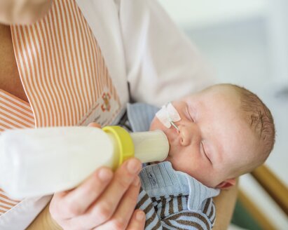 Nurse feeding a baby with a Medela SpecialNeeds Feeder