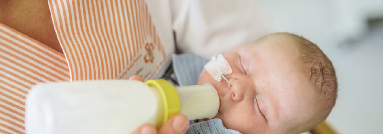 Nurse feeding a baby with a Medela SpecialNeeds Feeder