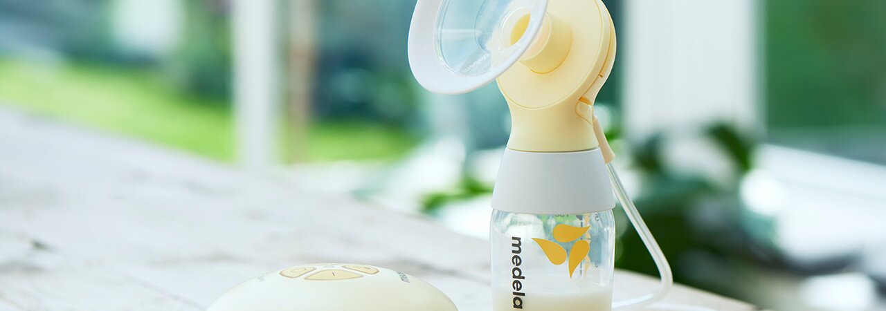 A set of Medela Hands-free Collection Cups with a Medela classic PersonalFit Flex™ double pumping kit, tubes not shown, sitting on a counter.