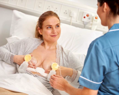 A woman gets advice on pumping from a healthcare professional in hospital.