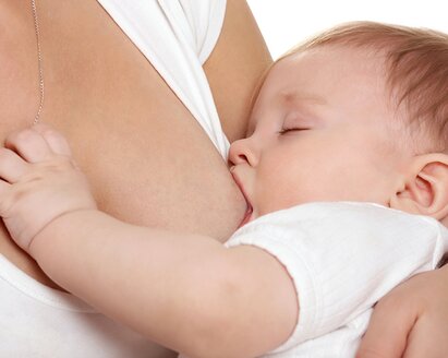 A close-up of a mom breastfeeding her baby.