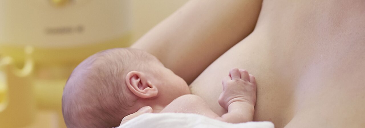 Close-up of a mom breastfeeding her baby.